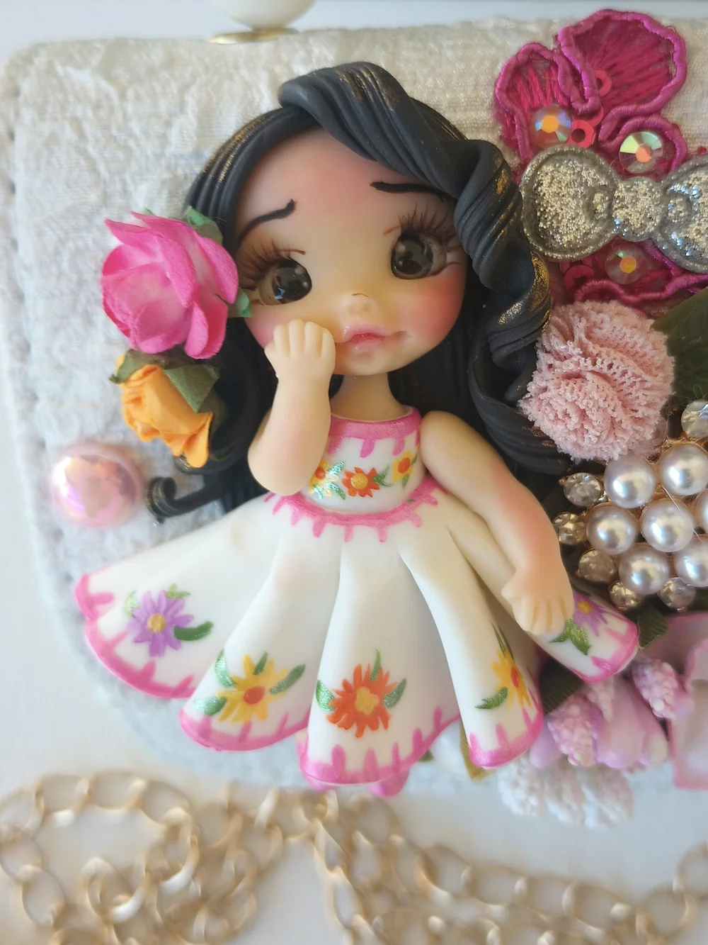 Handcrafted Pearl Handle Mini Bag With Clay Doll& Floral Applique.